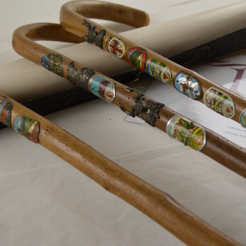 Oude wandelstok met souvenirs versierde plaatjes
